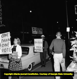 Demonstrators hold signs on voting rights while Gov. George Wallace visits Atlanta, 1963