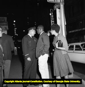 Demonstrators hold signs on voting rights while Gov. George Wallace visits Atlanta, 1963