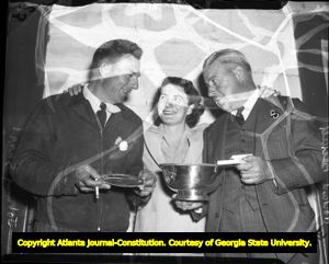 Golfer Louise Suggs with Johnny Suggs and trainer Howard 'Pop' Beckett, 1940s