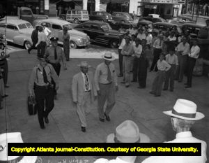 John Wallace on trial for murder entering the courthouse, 1948