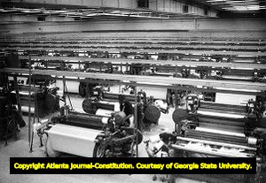 Textile worker monitors the rows of looms at the Jefferson Mill, 1979