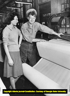 Married textile workers inspecting fabric at the Osprey Mill, 1945