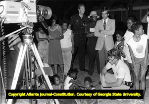News crews and neighbors watch as suspect Wayne Williams' house is searched in connection with the Atlanta Child Murders, 1981