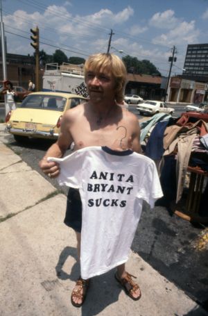 Pride parade vendor selling "Anita Bryant Sucks" t-shirts, 1977
