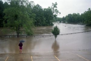 Onlooker watches the overflowing flooded river near Fayetteville, 1994