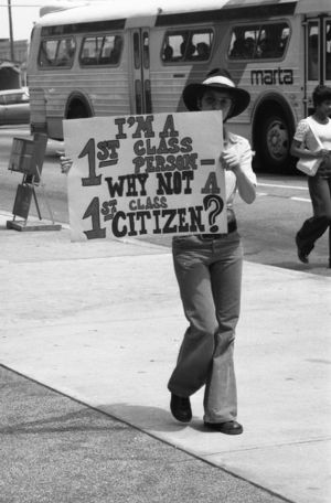LGBTQ rights activists protesting outside the Atlanta Journal-Constitution building over the termination of a gay employee and lack of news coverage, 1973