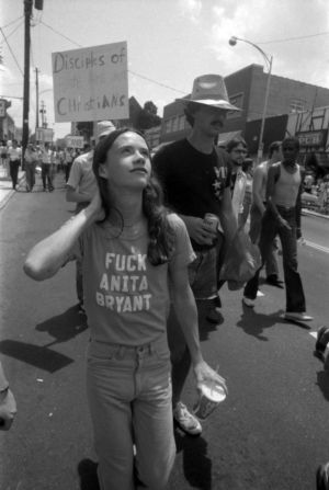 Pride parade participant wearing a "Fuck Anita Bryant" tshirt, 1977