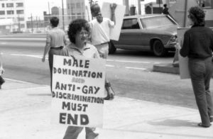 LGBTQ rights activists protesting outside the Atlanta Journal-Constitution building over the termination of a gay employee and lack of news coverage, 1973