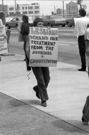 LGBTQ rights activists protesting outside the Atlanta Journal-Constitution building over the termination of a gay employee and lack of news coverage, 1973
