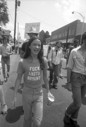 Pride parade participant wearing a "Fuck Anita Bryant" tshirt, 1977