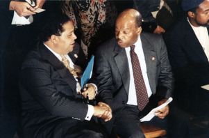 Representative John Lewis with Mayor Maynard Jackson at a press conference regarding racism and community action, 1990