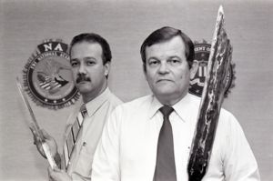 FBI Agents Weldon Kennedy and Diader Rosario pose with weapons confiscated from the Cuban prison riot in Atlanta, 1987