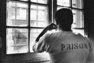 Incarcerated person looking out the window of the Atlanta Prison Farm, 1982