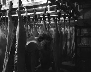 Incarcerated person working as a butcher at the Atlanta Prison Farm, 1953