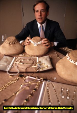 Jewelry designer Nicola Bulgari showing off pieces from the Bulgari jewelry collection, 1982