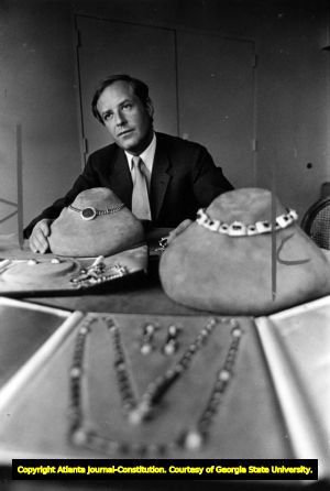 Jewelry designer Nicola Bulgari showing off pieces from the Bulgari jewelry collection, 1982