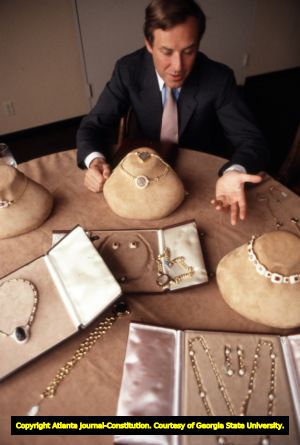 Jewelry designer Nicola Bulgari showing off pieces from the Bulgari jewelry collection, 1982