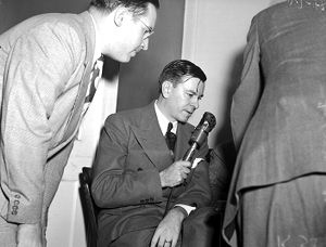 Herman Talmadge speaking into a radio microphone during the "Three Governors Controversy," Atlanta, Georgia, 1947.