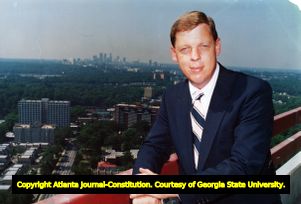 Representative Johnny Isakson poses with the Atlanta skyline in the background, 1986