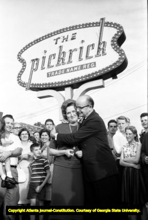 Lester Maddox and wife Hattie Virginia Cox pose outside The Pickrick restaurant defying court order to integrate the eatery, 1964