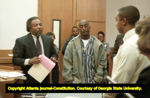 Tupac Shakur listens as his lawyer and an officer testify during a trial involving a shooting incident in Midtown, 1993