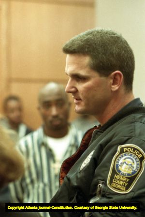 Tupac Shakur listens as an officer involved in the shooting incident testifies to the court, 1993