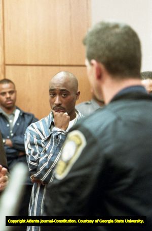 Tupac Shakur listens as an officer involved in the shooting incident testifies to the court, 1993