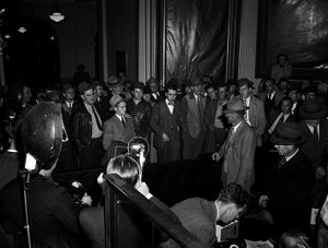 Roswell high school student James Rucker (young man on left in light suit and hat) is confronted by Talmadge supporter George M. Walker (second from right, in light suit), at the Georgia State Capitol, during the "Three Governors Controversy," Atlanta, Georgia, January 17, 1947.