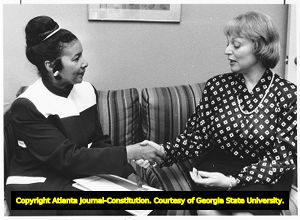Turner Broadcasting Vice President of Public Affairs Xernona Clayton receives a written apology from Linda Dorian of Business and Professional Clubs, 1987