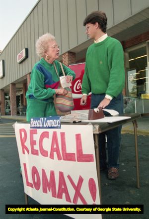 Volunteer Gabriel Sterling of the Task Force for Good Government talks with supporters while running a "Recall Lomax" petition table, 1991