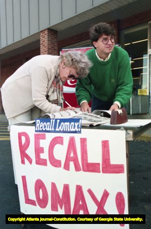 Volunteer Gabriel Sterling of the Task Force for Good Government talks with supporters while running a "Recall Lomax" petition table, 1991