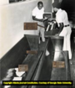Investigators search the crime scene at Ebenezer Baptist Church after the assassination of Alberta Williams King and Edward Boykin, 1974