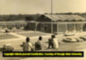 Students watch Eva Thomas High School after demonstrations had taken place in response to the school closing to comply with Georgia's desegregation plan, 1969