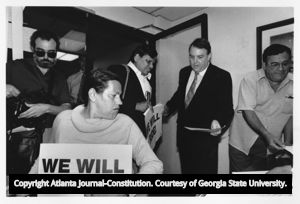 Demonstrators prepare signs against Greyhound's policies on people with disabilities using public transportation, 1988