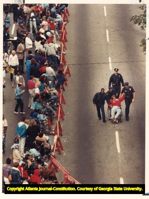 ADAPT demonstrators rally outside the American Public Transportation Association convention over the lack of accessibility for people with disabilities on public transportation, 1989