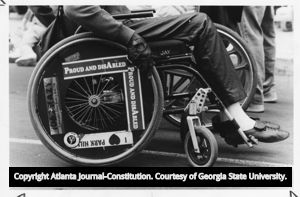 Wheelchair user during a demonstration against Greyhound buses advocating for better public transportation for people with disabilities, 1989