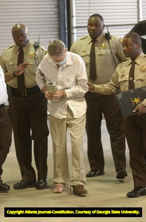 Murder suspect James Sullivan being escorted to the Fulton County Jail after being apprehended abroad, 2004