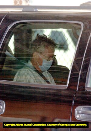 Murder suspect James Sullivan being escorted to the Fulton County Jail after being apprehended abroad, 2004