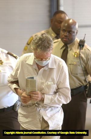 Murder suspect James Sullivan being escorted to the Fulton County Jail after being apprehended abroad, 2004