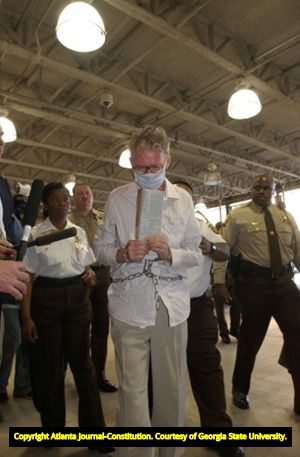 Murder suspect James Sullivan being escorted to the Fulton County Jail after being apprehended abroad, 2004