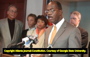 Family members of Lita McClinton and authorities discussing the apprehension of fugitive and murder suspect James Sullivan during a press conference, 2002