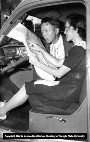 Fred and Wiladean Birchmore in front seat of car, looking over a map, Athens, Georgia (?), 1941 (?).