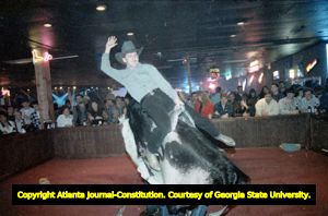 Patron, Craig Bunton, riding a mechanical bull at Mama's Country Showcase, Belvedere Park, Georgia, January 9, 1993.