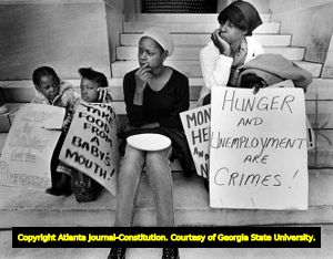 Rally in support of Atlanta's homeless population's right to food and shelter, demonstrators sitting on steps of the Georgia State Capitol building, Atlanta, Georgia, November 22, 1983.