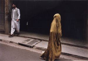 Muslim woman in full burqa walking on a city street, South Asia or Middle East, photograph by Jean Shifrin, 1992.