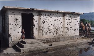 Young Muslim boy standing in doorway, photograph by Jean Shifrin, 1992.