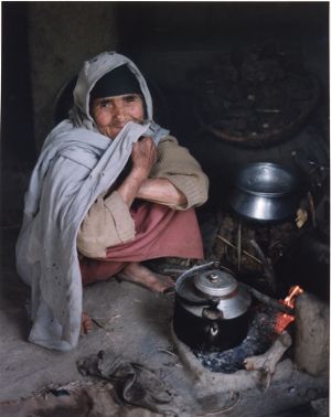 Elderly Muslim woman preparing food, Middle East or South Asia, photograph by Jean Shifrin, 1992.