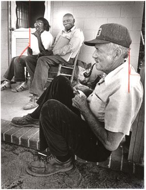 Hattie and Roger Boyd, sitting with their neighbor George Anderson on their front porch. All were landowners who signed leases with kaolin companies, Georgia, September 29, 1983.