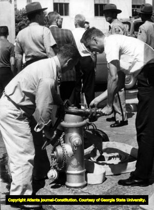 Workers preparing fire hoses to use against Civil Rights demonstrators, Atlanta, Georgia, May 1960.