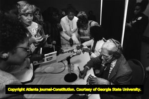Rosa Parks signing autographs at the Conference on Women and the Constitution, Atlanta, Georgia, February 12, 1988.